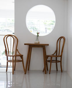 Rear view of empty chairs and table at home