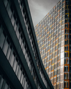 Low angle view of modern buildings against sky in city