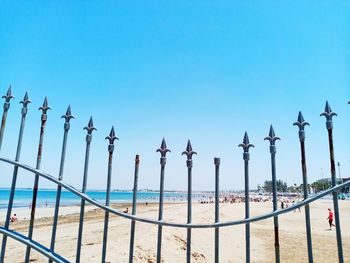 Panoramic view of fence against clear blue sky