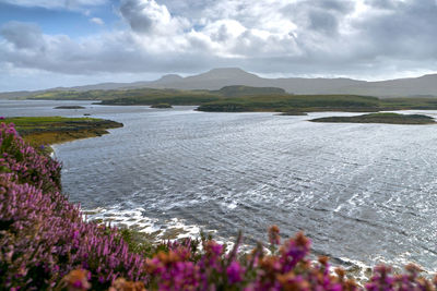 Scenic view of sea and mountains against sky