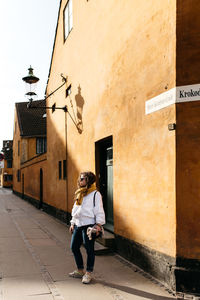 Rear view of man standing in front of building