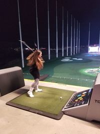 Woman playing with umbrella at night