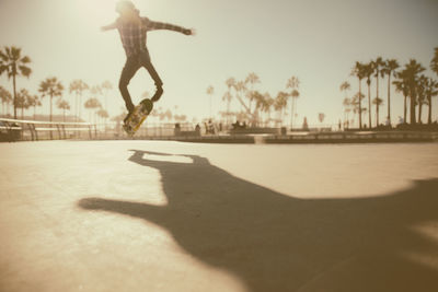 Shadow of man skateboarding on skateboard