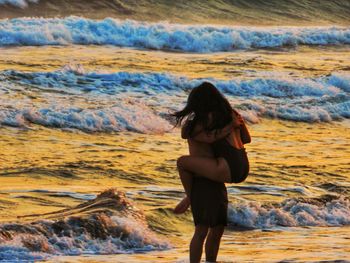 Full length of woman standing on beach