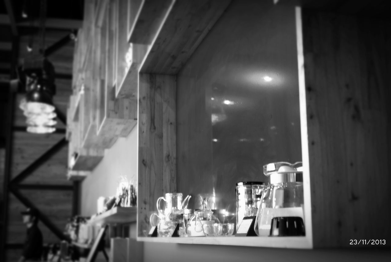 indoors, food and drink, table, architecture, food, focus on foreground, night, built structure, illuminated, window, incidental people, glass - material, restaurant, still life, building exterior, no people, selective focus, home interior, in a row