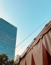 Low angle view of modern building against clear blue sky