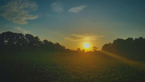 Scenic view of field against sky during sunset