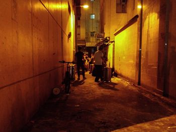 Full length of woman in illuminated city at night