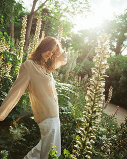 Woman standing by tree