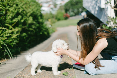 Woman playing dog on road