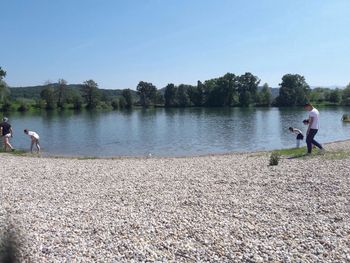 Woman standing by lake