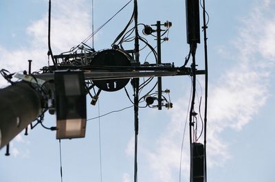 Low angle view of telephone pole against sky