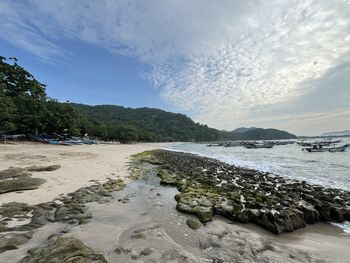 Scenic view of beach against sky during sunset