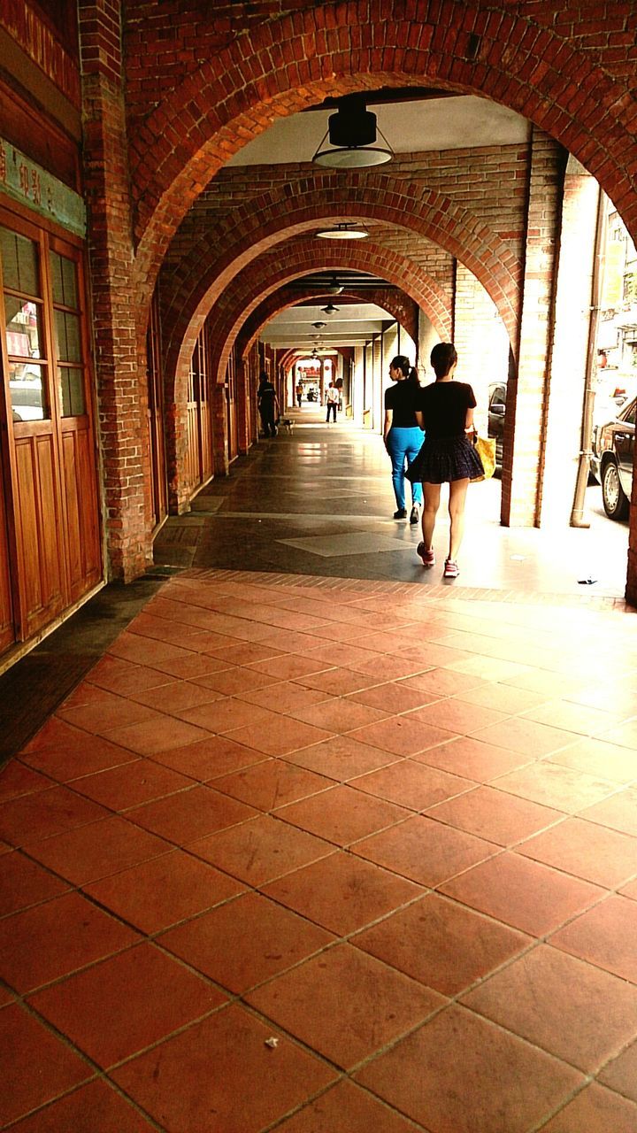 men, lifestyles, walking, full length, person, architecture, the way forward, built structure, leisure activity, indoors, rear view, arch, tunnel, transportation, city life, large group of people, travel, on the move