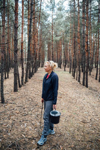 Full length of woman standing in forest