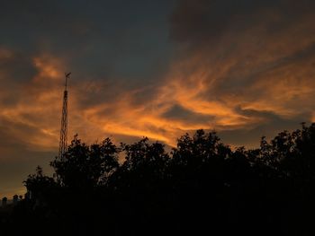 Low angle view of silhouette trees against sky at sunset