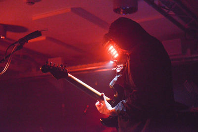 Man playing guitar at music concert