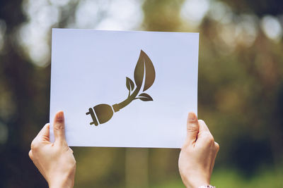 Close-up of hand holding paper outdoors