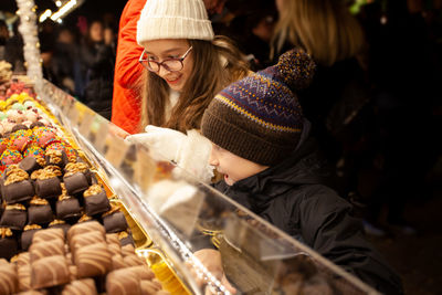 Midsection of woman in traditional clothing at store during winter