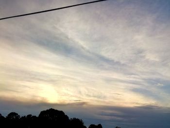 Low angle view of silhouette trees against sky during sunset