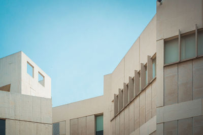 Low angle view of building against clear blue sky