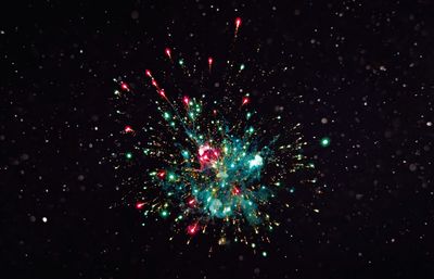 Low angle view of firework display at night