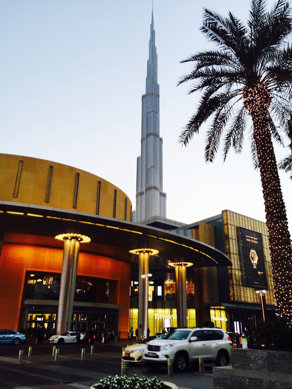 architecture, built structure, building exterior, clear sky, car, city, famous place, transportation, low angle view, travel destinations, history, travel, road, street, land vehicle, capital cities, architectural column, international landmark, tree, tower