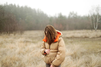 Woman standing on field during winter