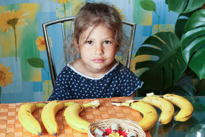 Portrait of cute baby girl eating food