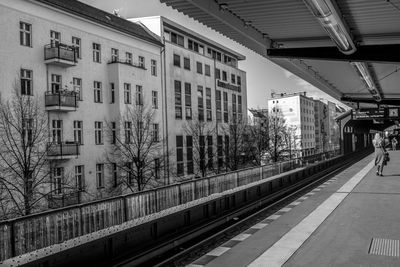 Railroad tracks in city against sky