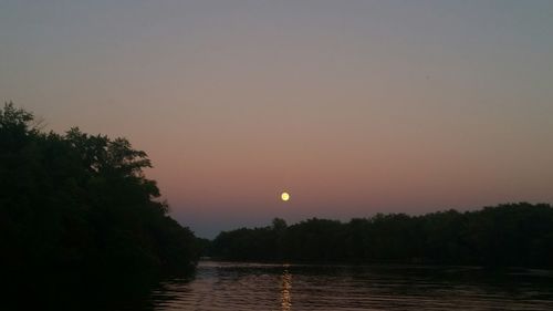 Scenic view of calm lake at sunset