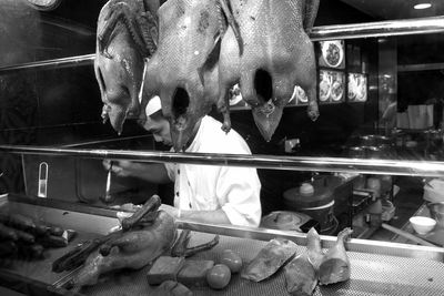 Midsection of man feeding horse