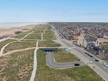 High angle view of townscape by sea against sky