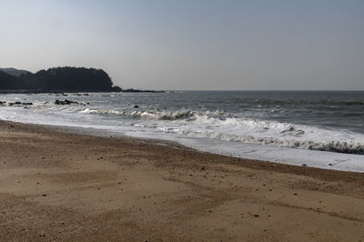 Scenic view of beach against clear sky