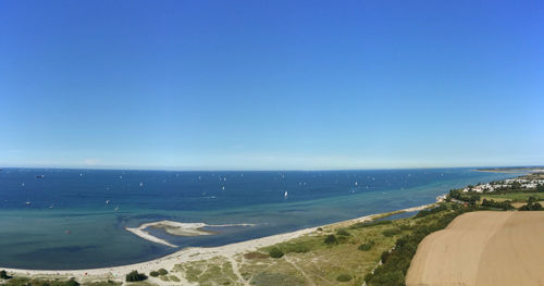 Scenic view of sea against clear blue sky