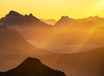 Scenic view of mountains against sky during sunset