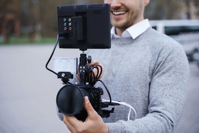 Midsection of man using mobile phone