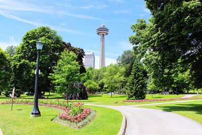 Park by cn tower against sky