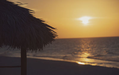 Scenic view of beach against sky during sunset