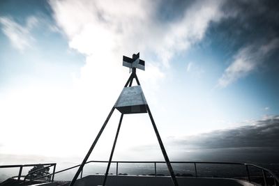 Low angle view of cross against sky