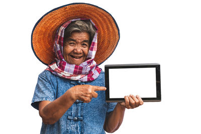 Portrait of man holding mobile phone against white background