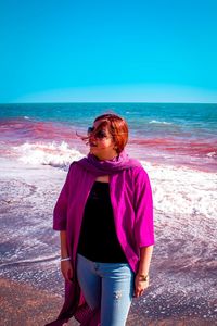 Rear view of woman standing at beach