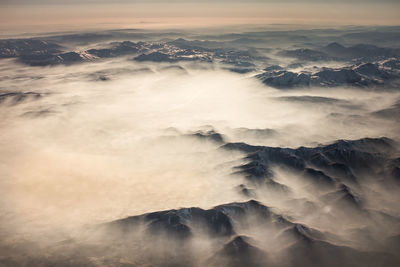 Aerial view of mountains against sky during sunset