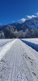 Scenic view of snow covered mountains against sky