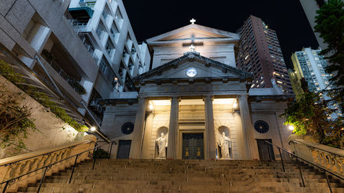 Low angle view of illuminated building against sky