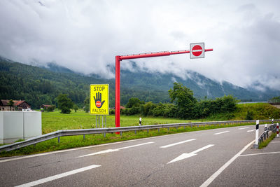 Road sign against sky