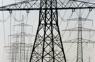 Low angle view of electricity pylon against sky