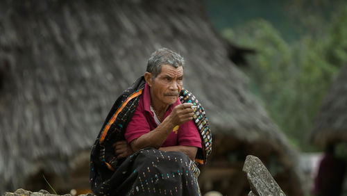 Woman sitting on rock