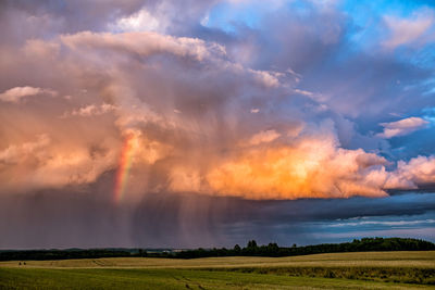 Rainbow over farm field