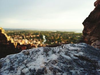 Close-up of snow covered rock against sky